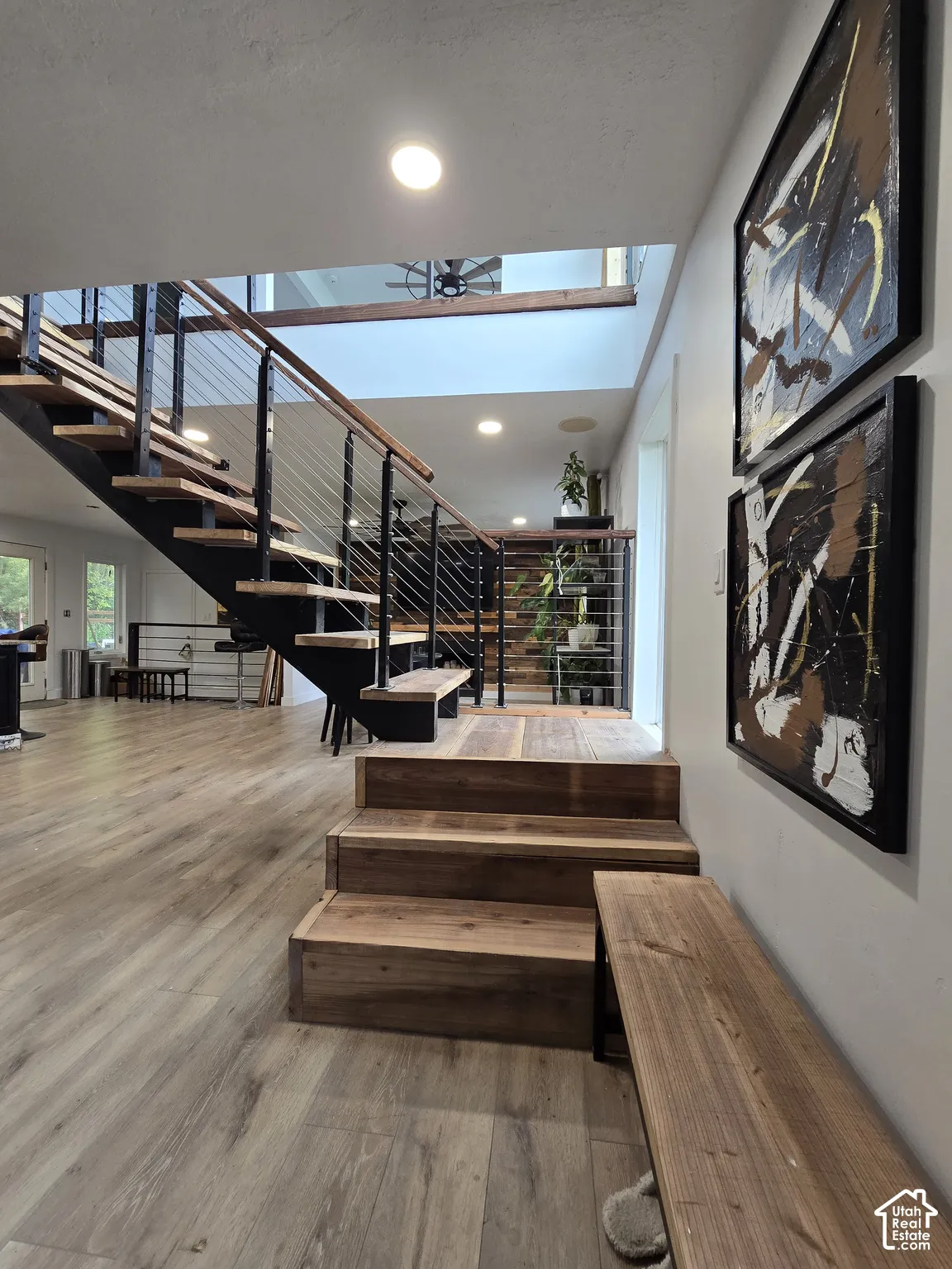 Open-tread staircase with wood risers and metal railings