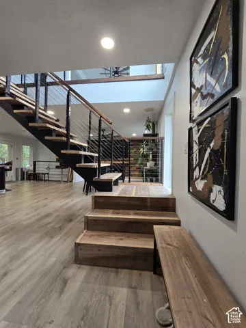 Open-tread staircase with wood risers and metal railings