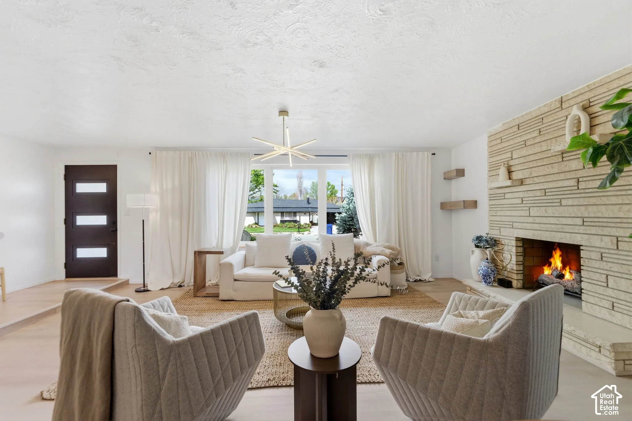 Light wood-finish flooring with a textural area rug