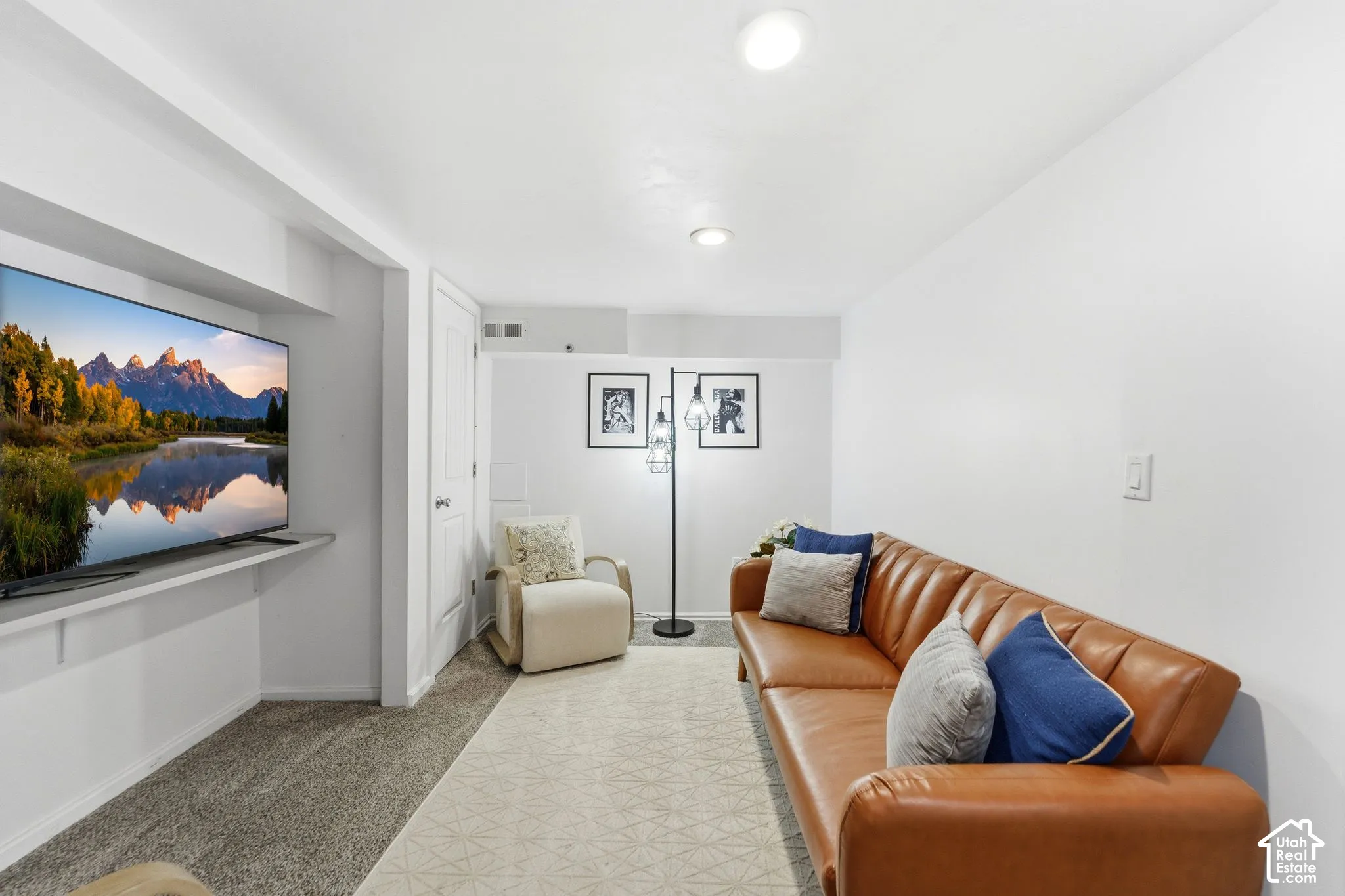 Recessed ceiling lighting, mixed carpet and area rug flooring, and a wall-mounted display shelf