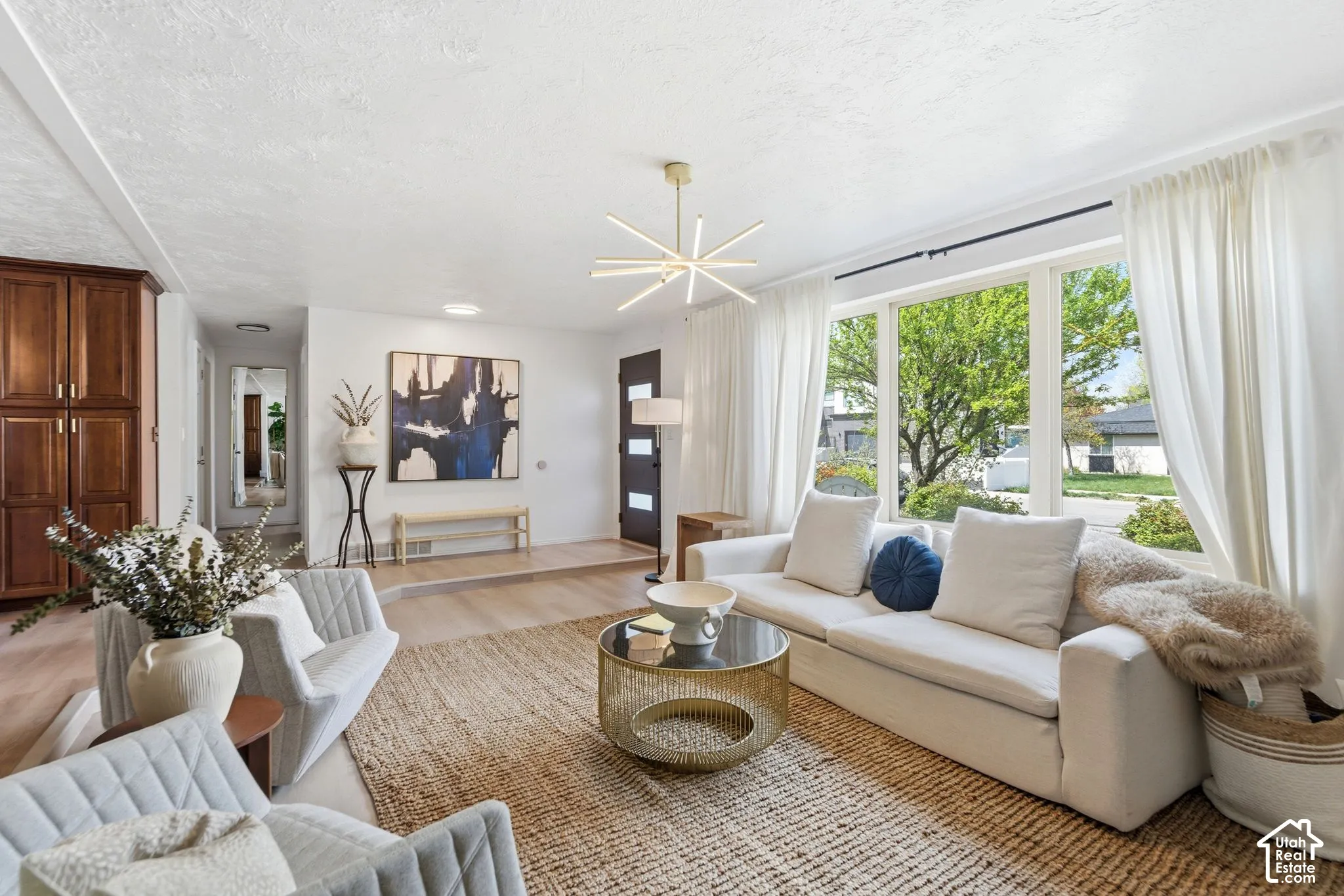 Expansive windows, wood-finish flooring, and built-in wood cabinetry