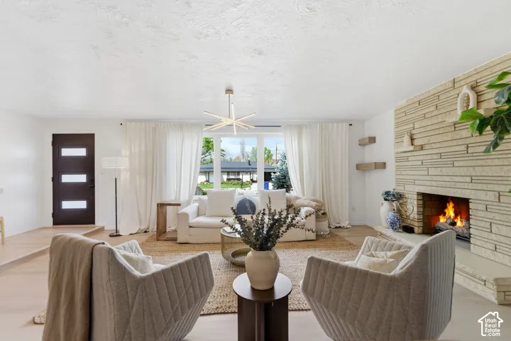 Light wood-finish flooring with a textural area rug