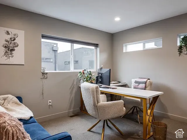 Recessed lighting, multiple windows, and carpeted flooring