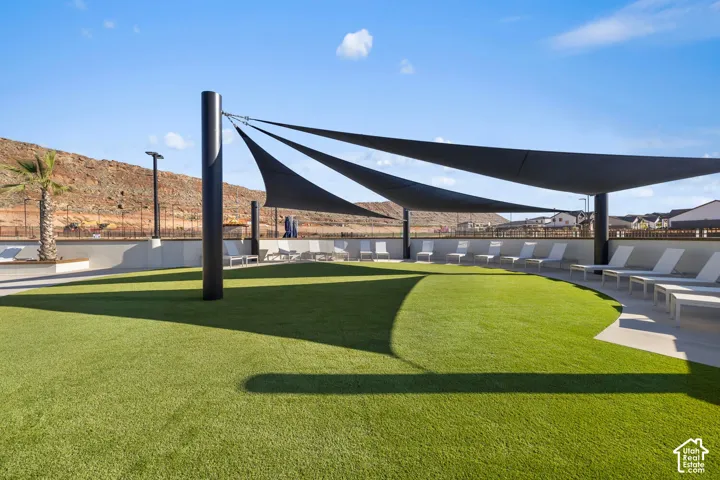 Expansive artificial turf area with shade sails