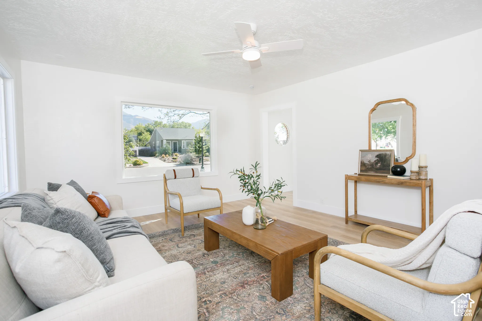 Recessed lighting, wood-finish flooring, and a ceiling fan