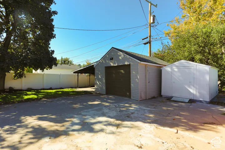 Detached garage, covered carport, and additional outdoor storage shed
