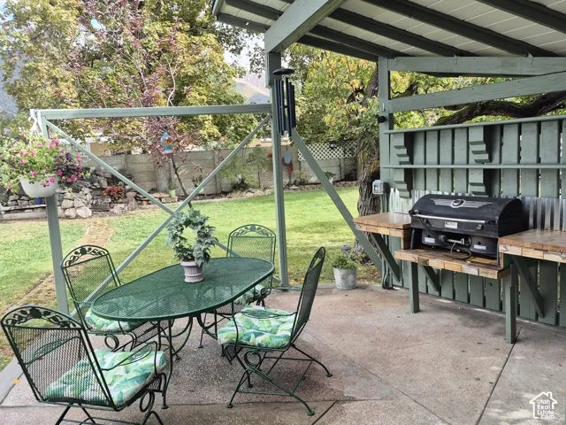 Patio featuring a built-in outdoor cooking area with wood-finish countertops and a concrete surface