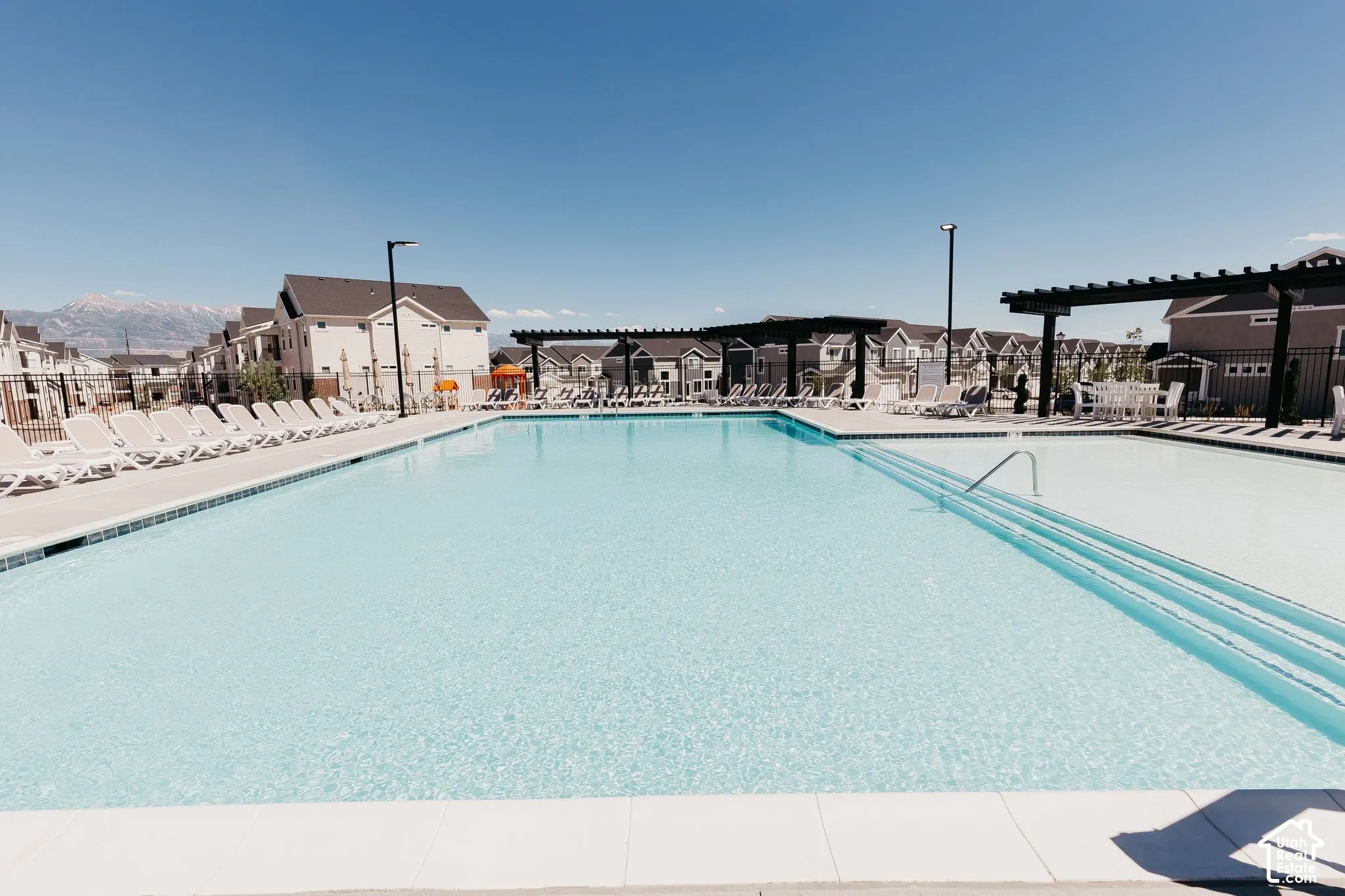Expansive swimming pool with integrated steps and a white tile border