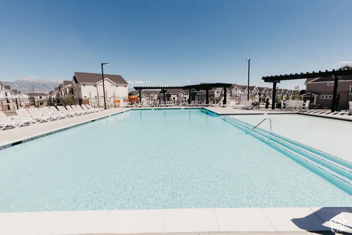 Expansive swimming pool with integrated steps and a white tile border