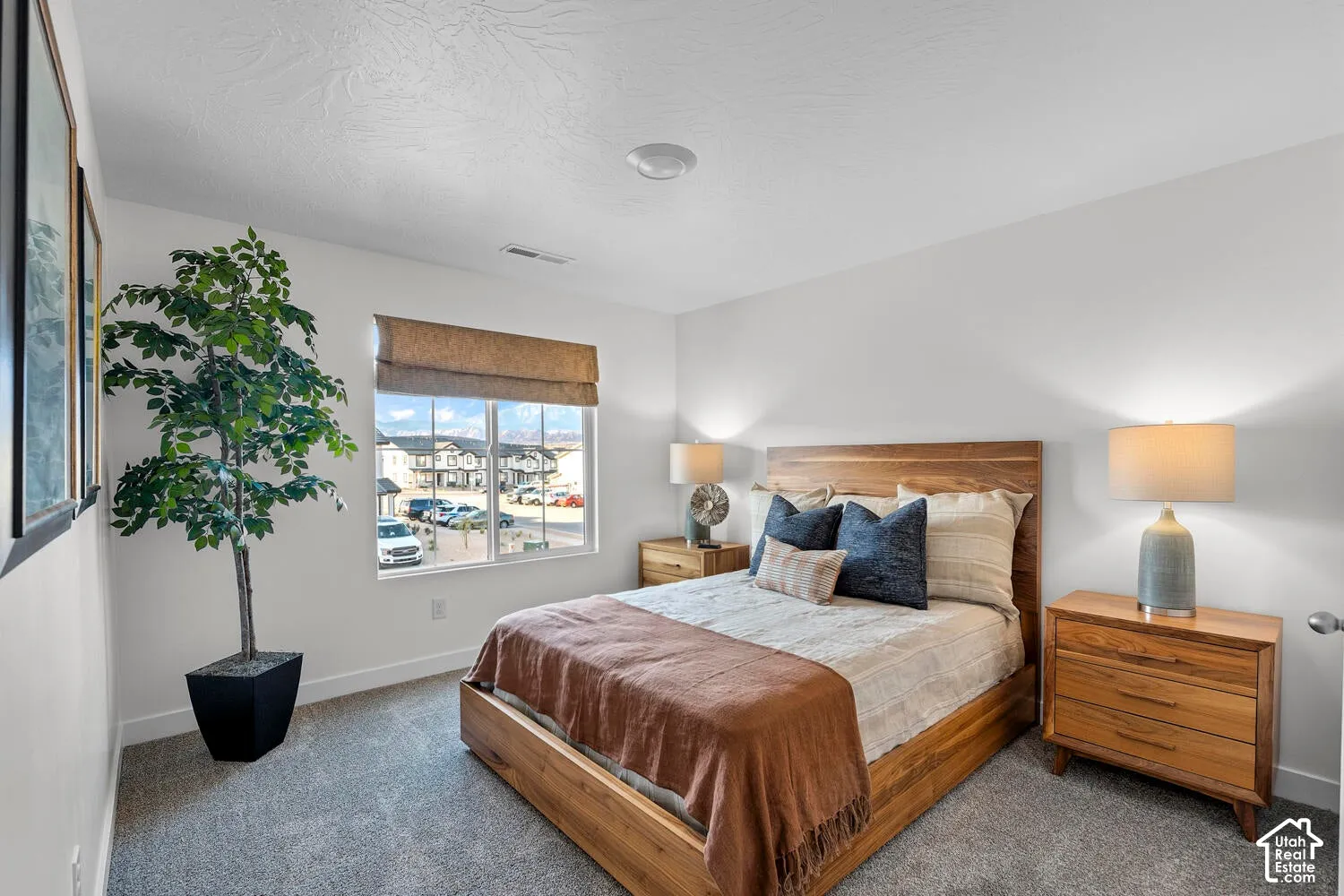 Carpeted room with a window, white walls, and a light fixture