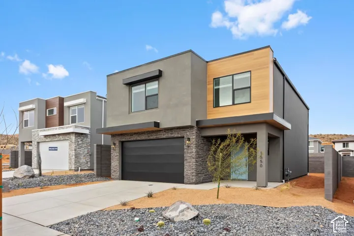 Modern exterior with wood-finish siding, stone accents, and a concrete driveway