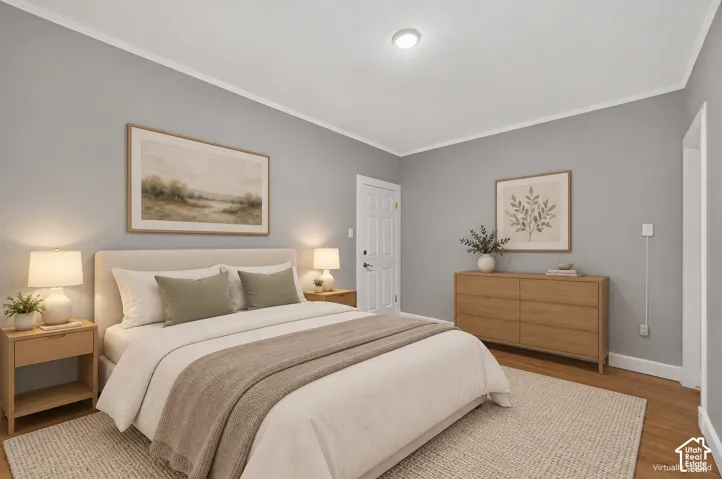 Hardwood-style flooring complemented by light gray walls and white crown molding