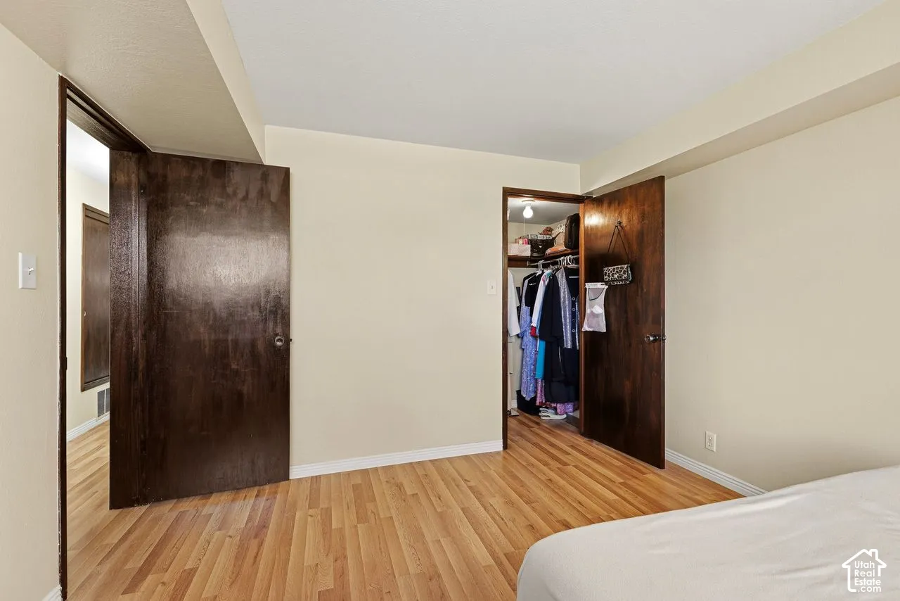 Primary bedroom with walk in closet.New laminate flooring