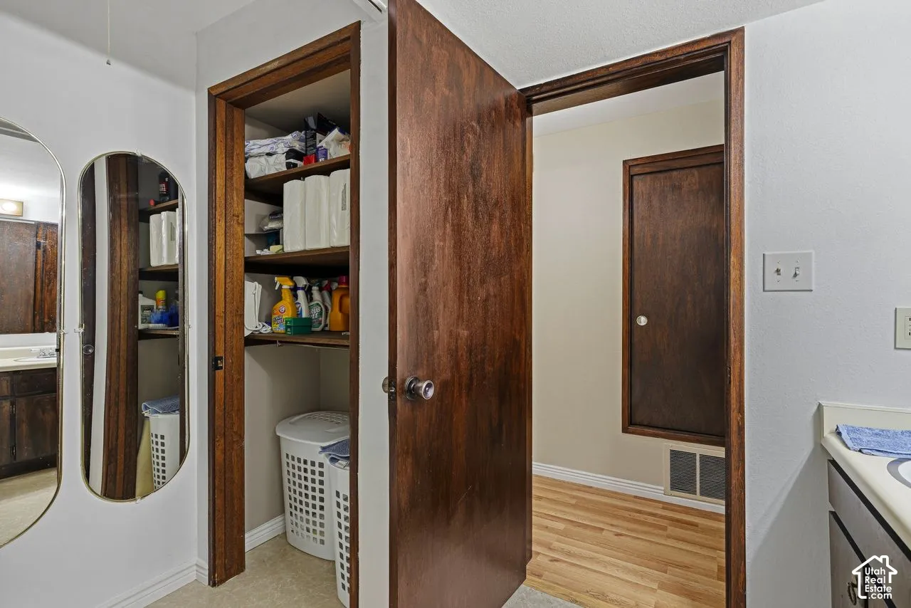 White painted walls with wood-finish trim, wood-finish doors, and a built-in closet with wood-finish shelving