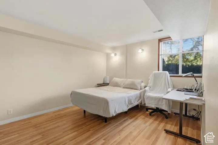 Primary bedroom, New laminate flooring and a window with natural light