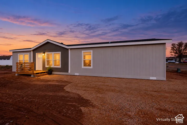 Contemporary exterior with a covered front entrance and wood deck