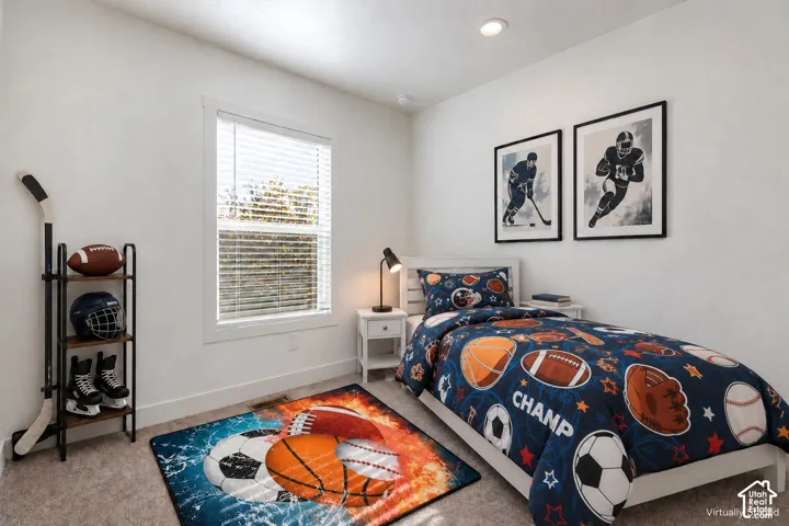 Recessed lighting with a textured ceiling, a window with blinds, and white trim