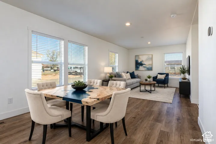 Wood-finish flooring throughout, white walls, recessed lighting, and multiple windows with blinds