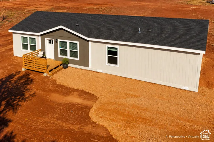 Exterior featuring a dark shingle roof, light-toned siding, dark accent siding, and a wooden entry deck