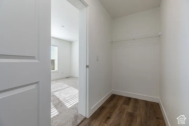 Primary Bedroom closet featuring wood-finish flooring and integrated wire shelving
