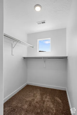 Built-in shelving and hanging rods, recessed ceiling light, and a small window