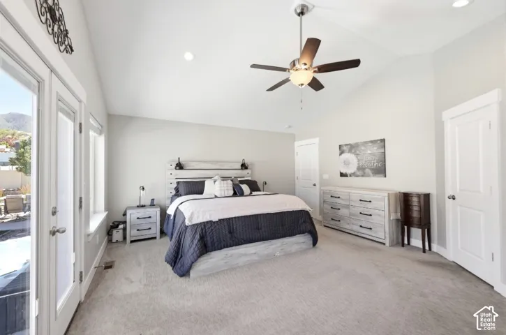 Carpeted room featuring a vaulted ceiling with a ceiling fan and recessed lighting