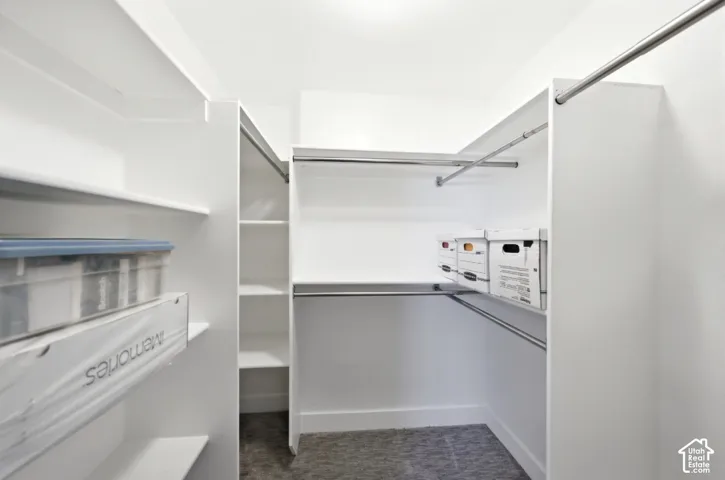 Custom closet system featuring multiple shelving units and chrome hanging rods