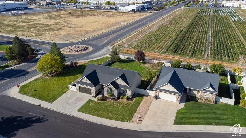 Street-facing property with an attached two-car garage, concrete driveway, and a well-maintained lawn