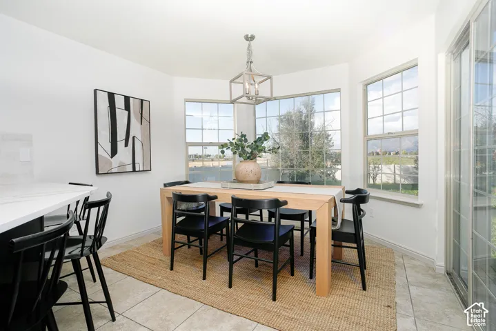 Bay window dining area with multiple picture windows, a sliding glass door, and tiled flooring
