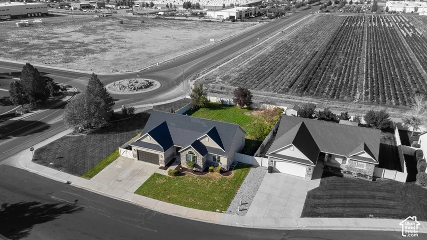 Ranch-style residence with a dark shingle roof and an attached two-car garage