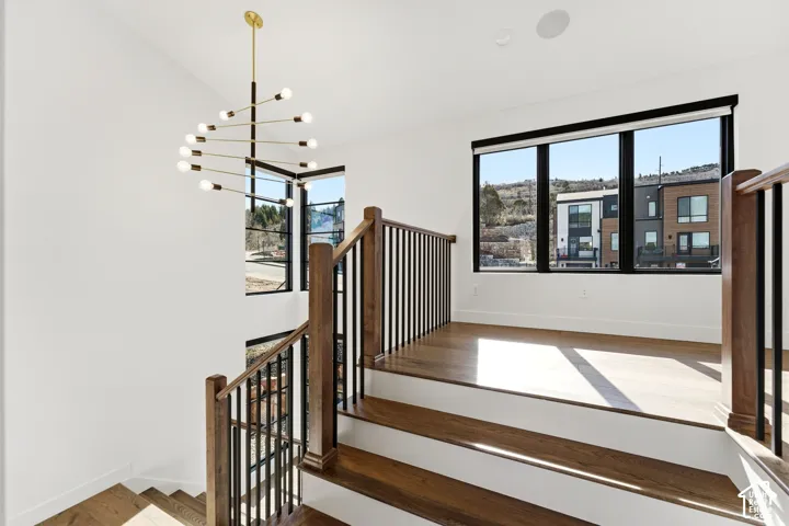 Hardwood stairs with wood railings and black metal balusters