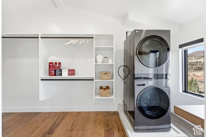 Built-in custom closet system, wood-finish flooring, stackable washer and dryer, and a recessed window