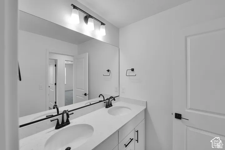 Double vanity with integrated sinks, quartz countertop, and matte black fixtures