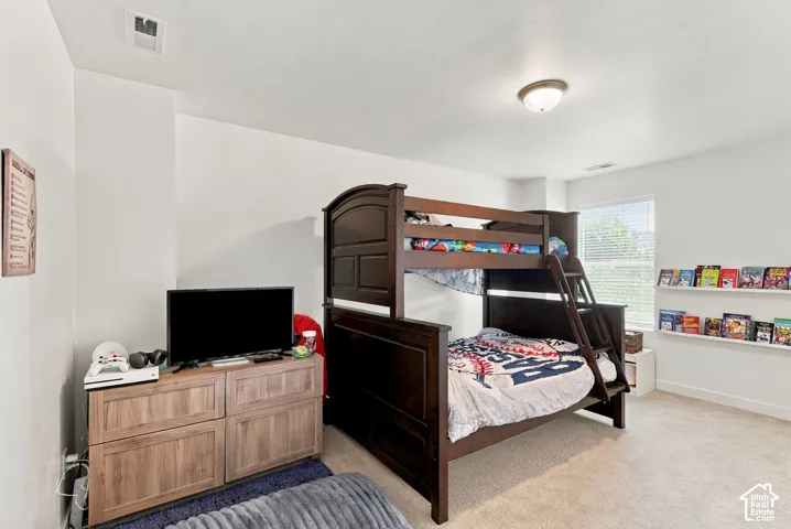 Recessed lighting and a flush-mount ceiling light illuminate the space, featuring a window with blinds