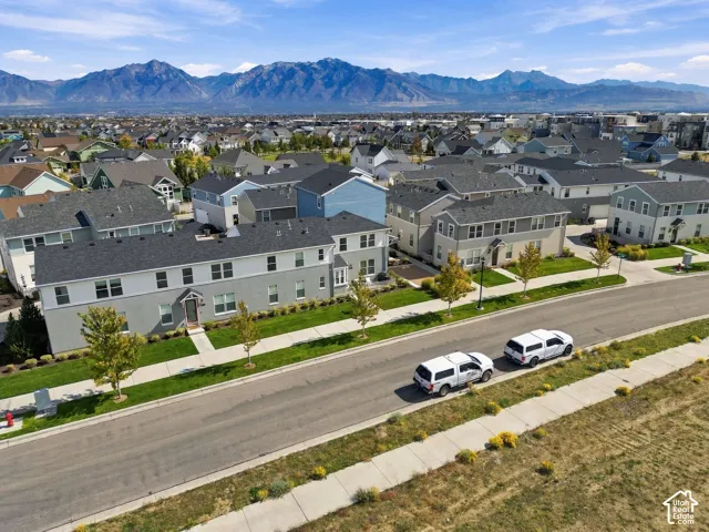 Neighborhood setting with paved streets, mature landscaping, and mountain backdrop