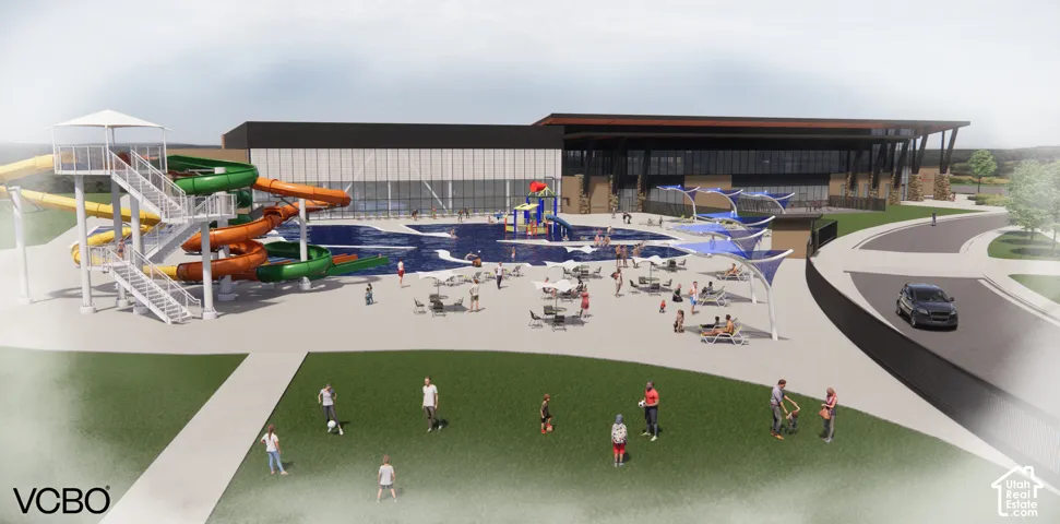 Outdoor aquatic center featuring multiple waterslides, a large pool, and a splash pad