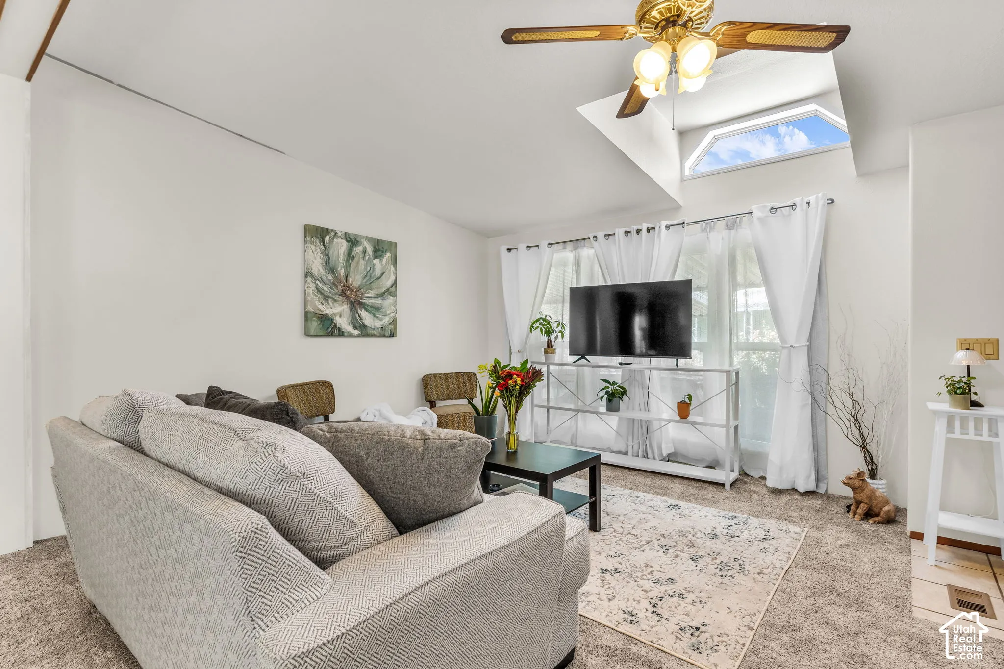 Vaulted ceiling with skylight and ceiling fan
