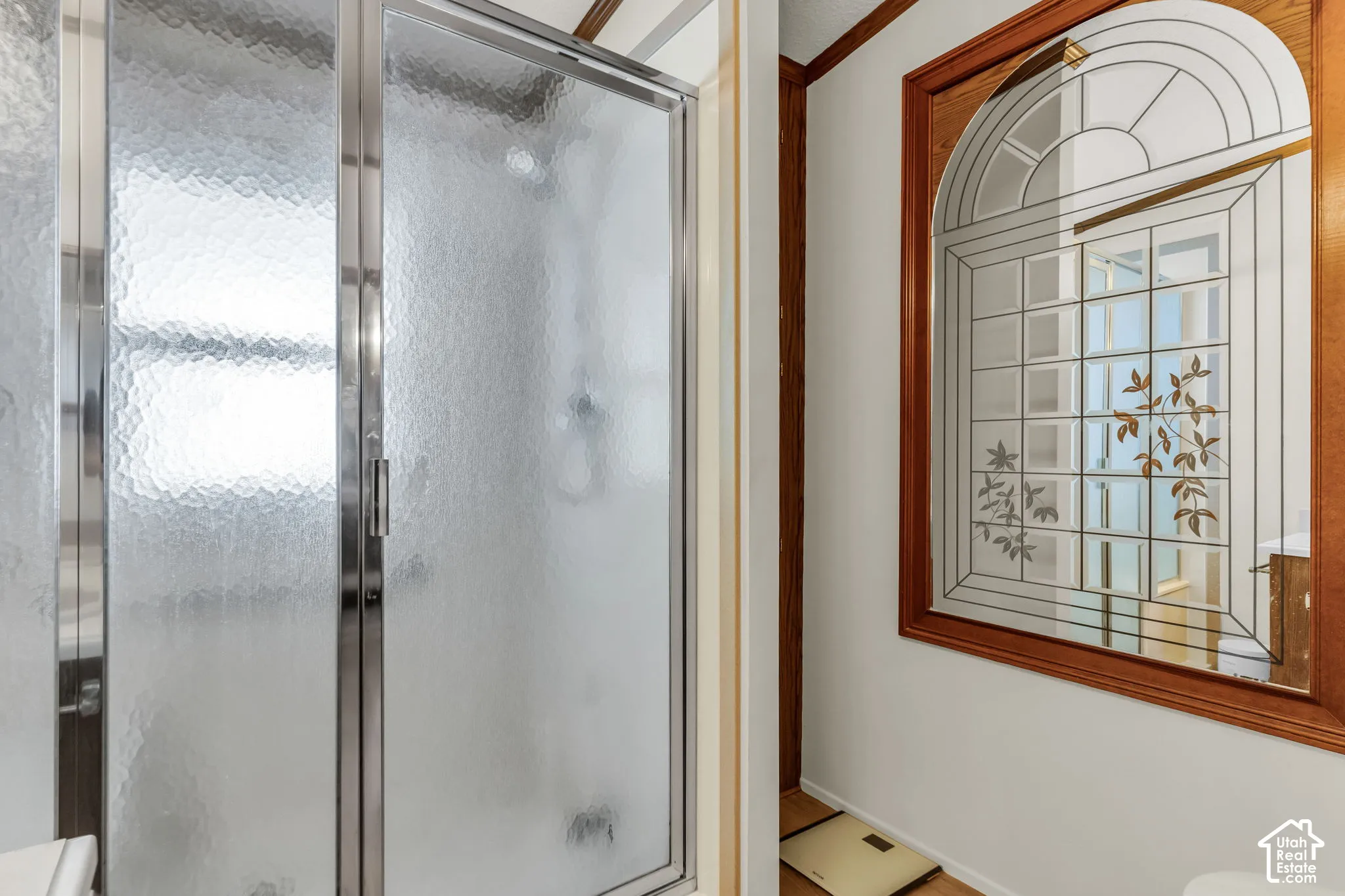 Shower enclosure with textured glass panels and chrome framing