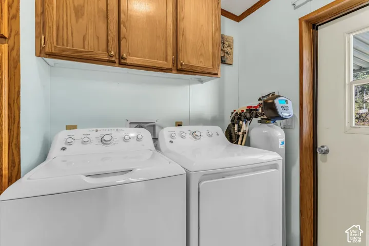Built-in wood-finish cabinetry, light blue wall paneling, and a utility door with a window