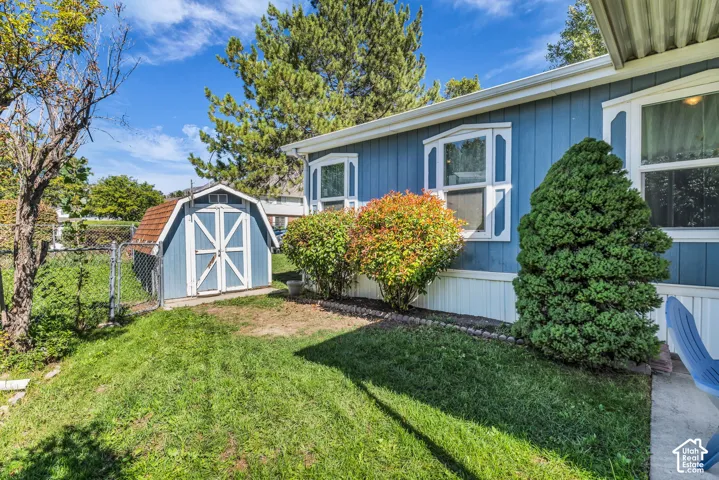 Blue siding exterior with white trim and bay windows