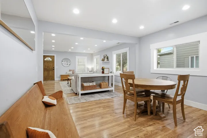 Open-concept living space featuring wood-finish flooring, recessed lighting, and white trim