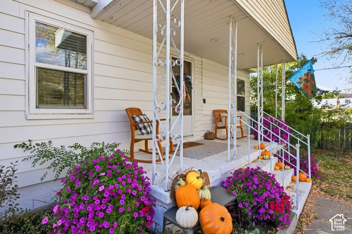 Covered front porch with decorative metal railing and support columns
