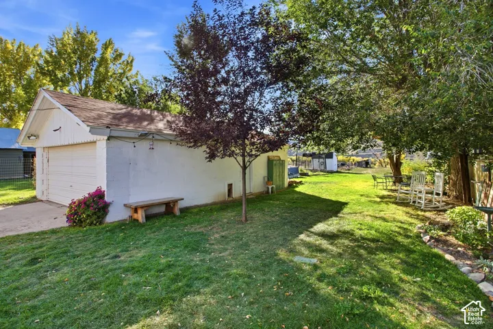 Detached garage with a pitched roof and a concrete driveway