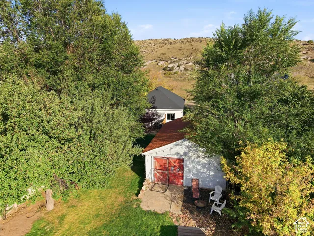 Detached garage with red doors and a corrugated metal roof