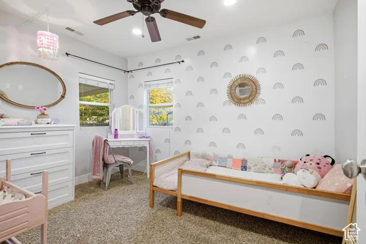 White walls with decorative accents, two windows with blinds, a ceiling fan with integrated lighting, recessed lighting, and carpeted flooring