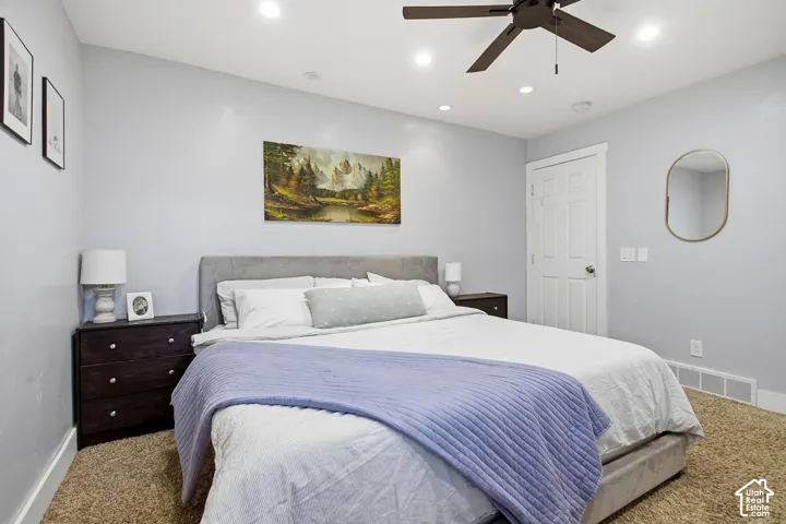 Plush carpet flooring, recessed lighting, and a ceiling fan