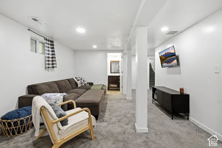 Recessed lighting, light gray carpeting, and white walls
