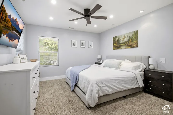 Recessed lighting, ceiling fan, window with blinds, and wall-mounted television
