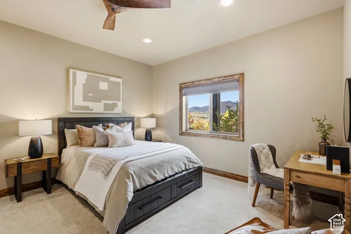 Recessed lighting, ceiling fan with wood-finish blades, and a window with wood-finish trim