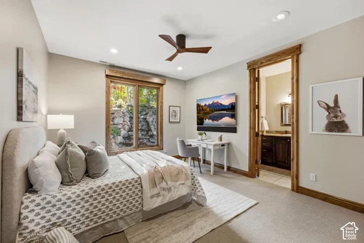 Recessed lighting, wood-finish ceiling fan, wood-trimmed window, wood-trimmed doorway, and carpet flooring